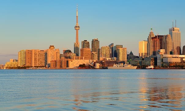 City skyline across water at golden hour